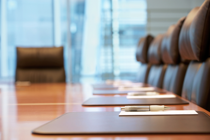 Conference room with brown leather chairs and a long table
