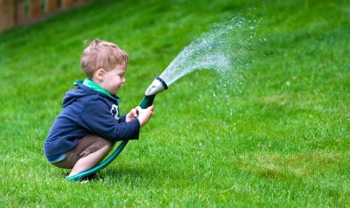 Child using garden hose
