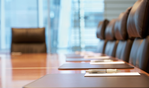 Conference room with brown leather chairs and a long table
