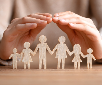 Hands protecting a family 